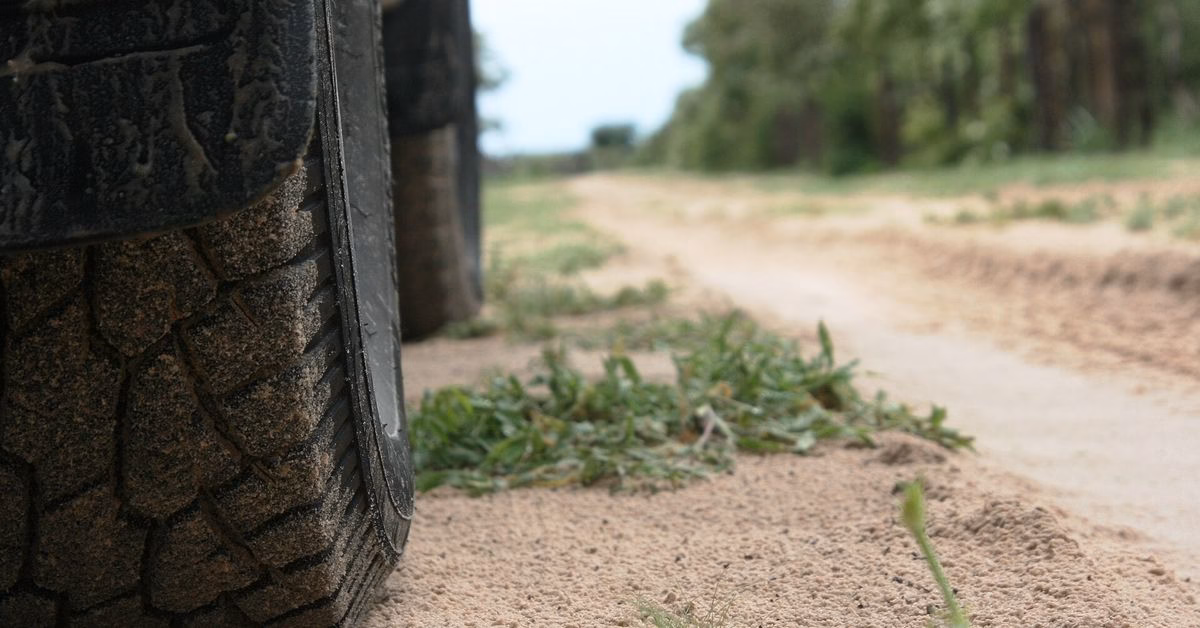 Toyota Hilux 4x4 tracks on a sandy road in Namibia
